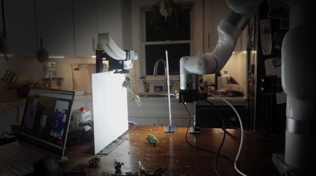 The Ai Bucker's robotic arm positioned at the backlit branch station